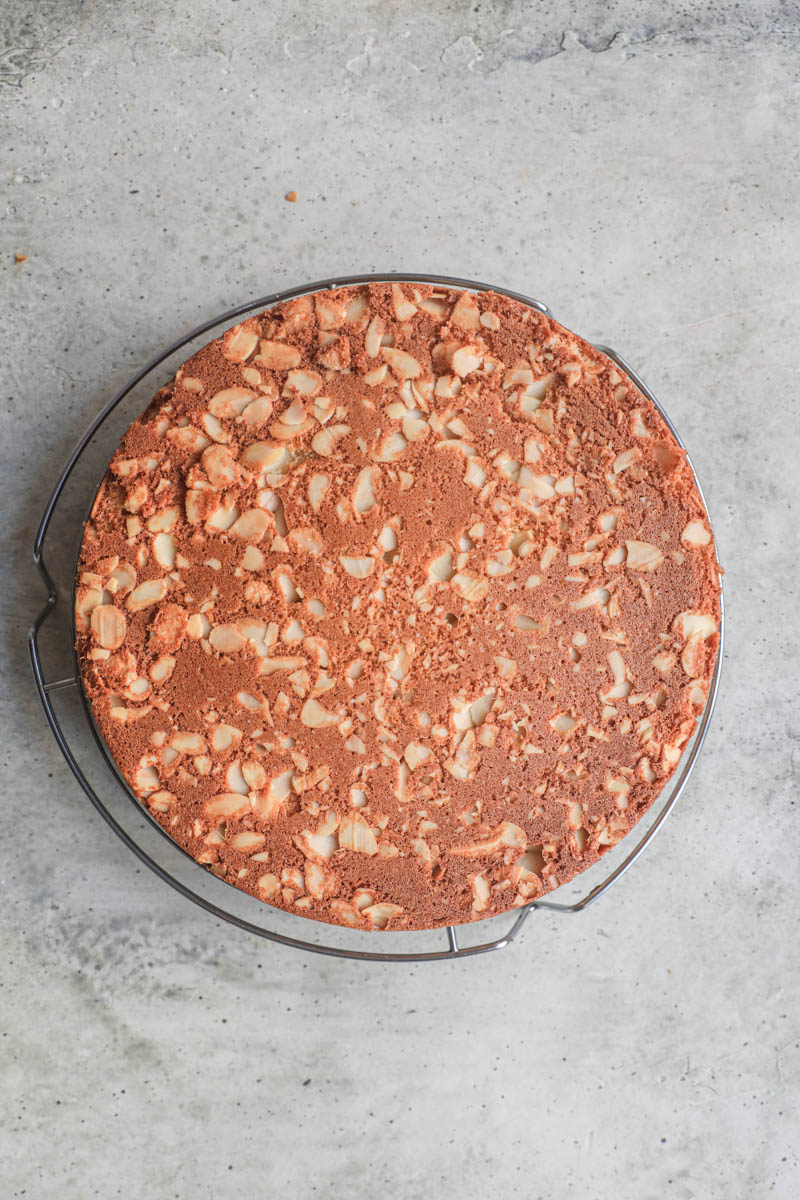 The almond cake on a wire rack.