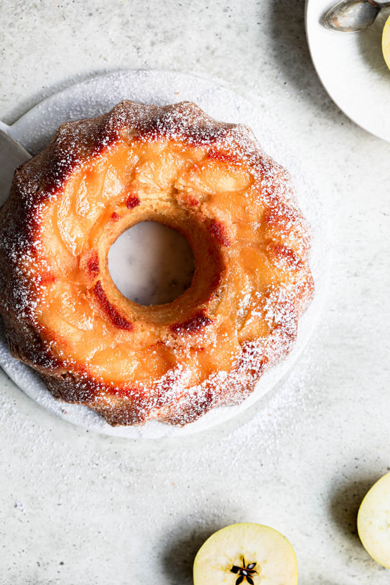 Overhead shot of the apple yogurt cake on a marble platter