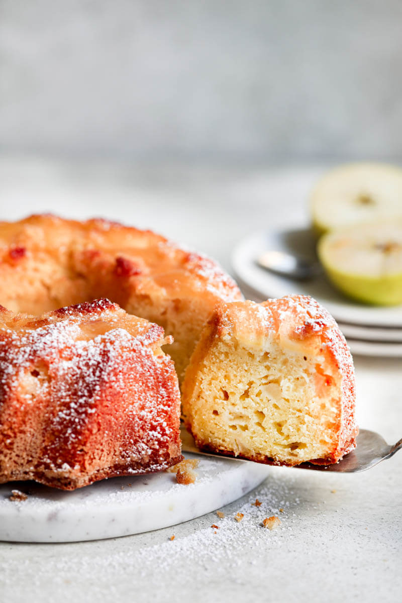 Overhead shot of the apple yogurt cake on a marble platter