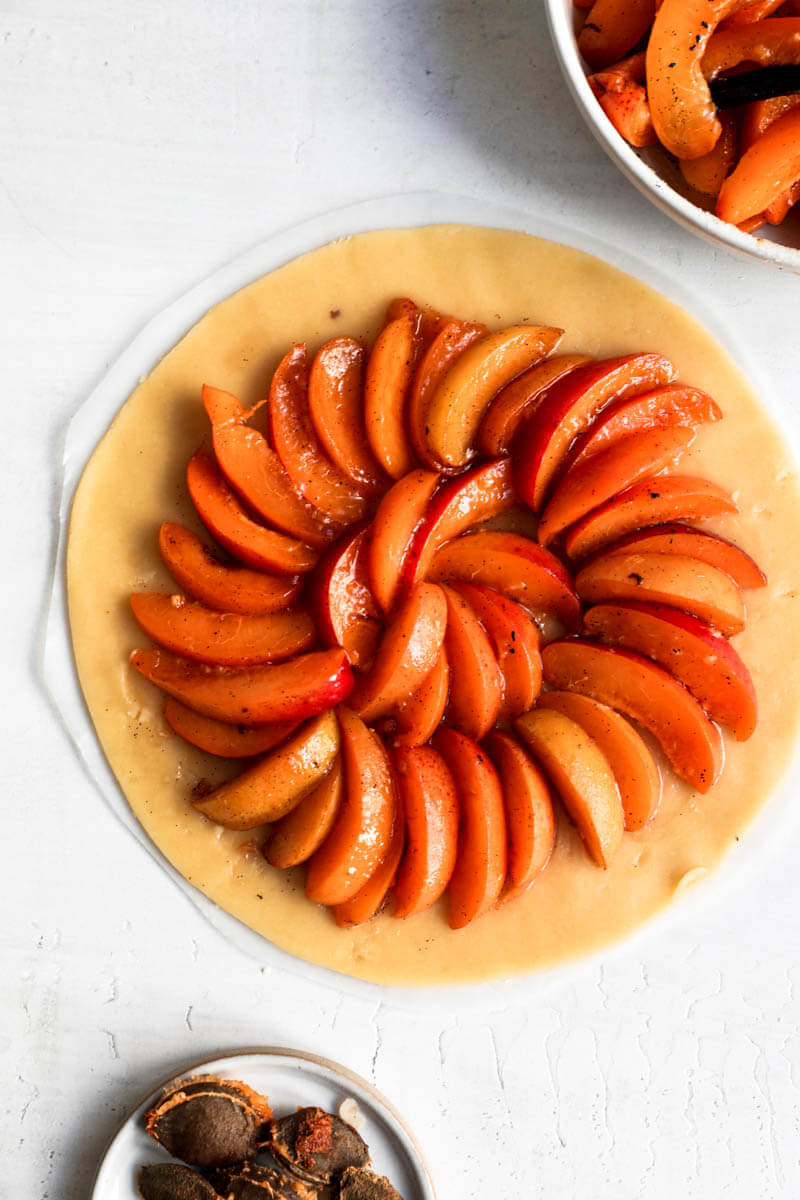 Overhead shot of the crust filled with the sliced apricots.