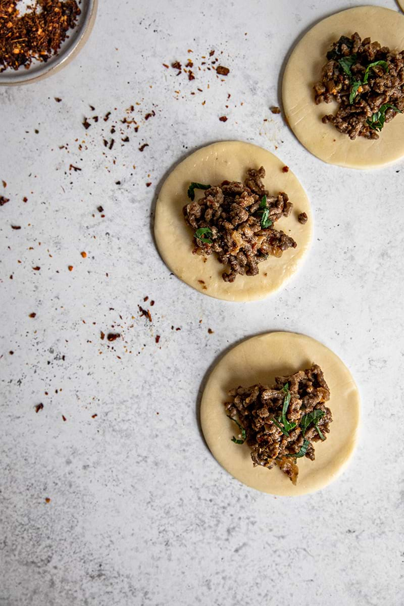 Filling the beef empanada discs