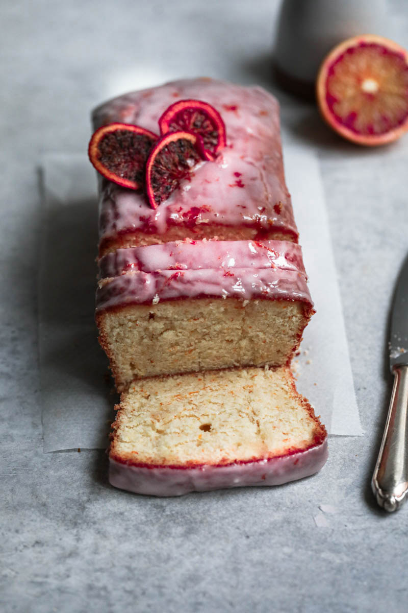 Sliced blood orange cake seen from the front.