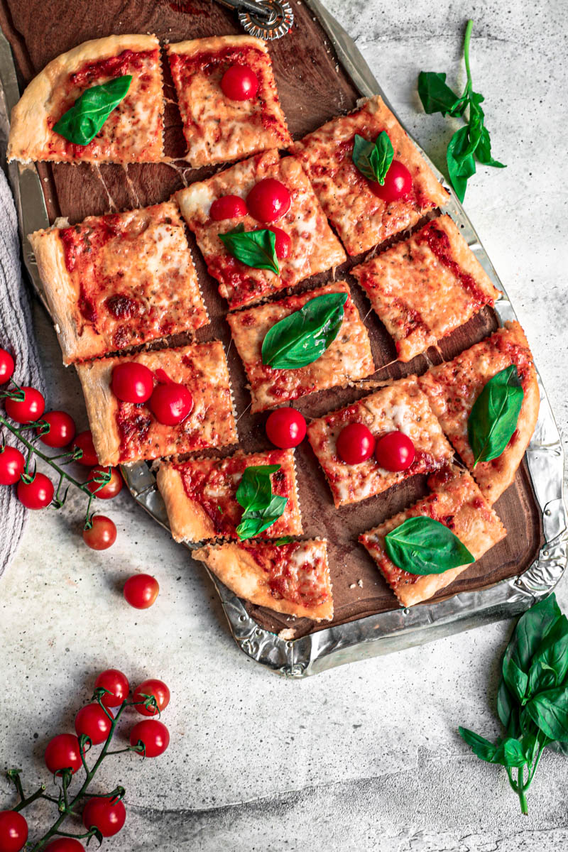 Overhead shot of the baked margherita pizza on a wooden board