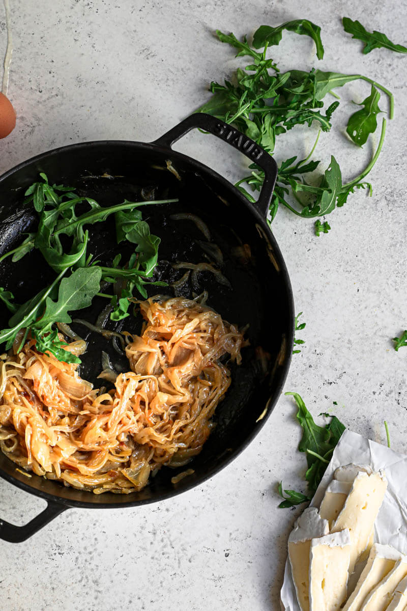 Overhead shot of the caramelized onion in a black pan