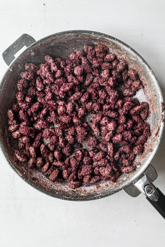 The candy-coated roasted almonds inside the pan.