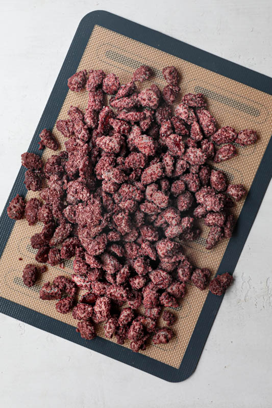 The candy-coated roasted almonds over a silicon mat.