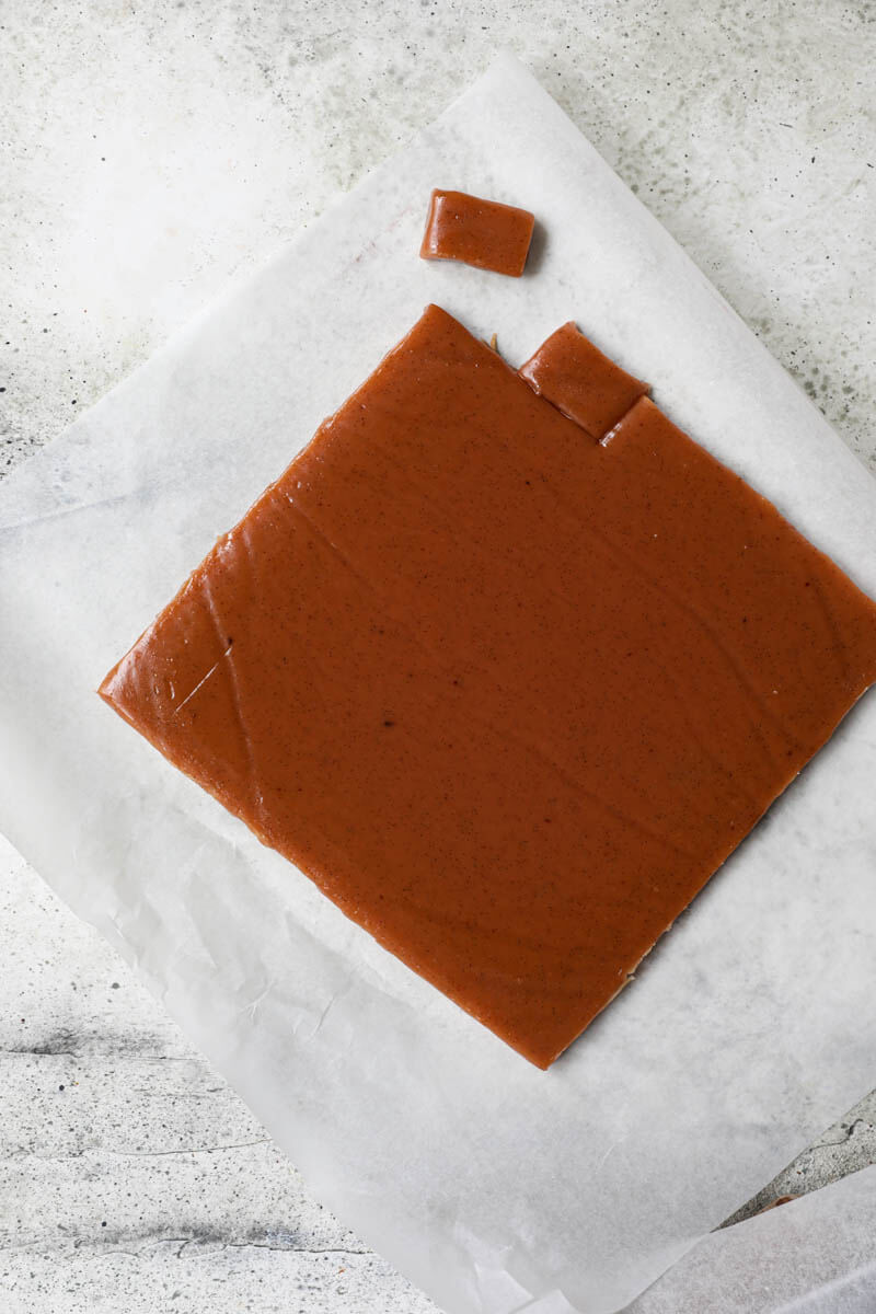 Sliced caramel candy on a piece of parchment paper