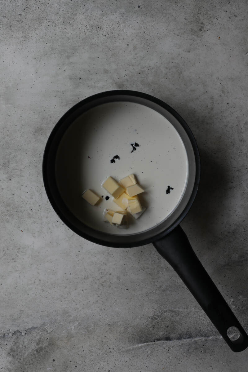 A pan with cream, butter, and vanilla bean