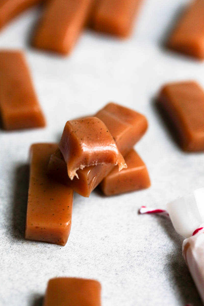 One bitten caramel on top of 2 other caramels