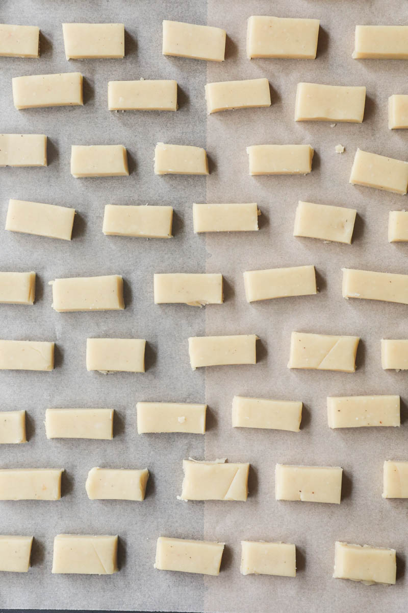 The parmesan cheese cookies placed on a baking tray lined with parchment paper.