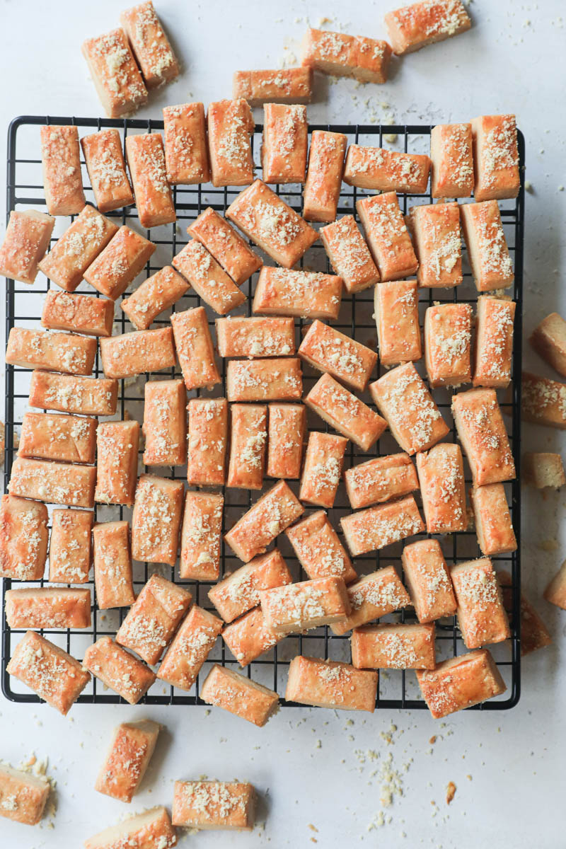 The baked parmesan cheese cookies on a wire rack.