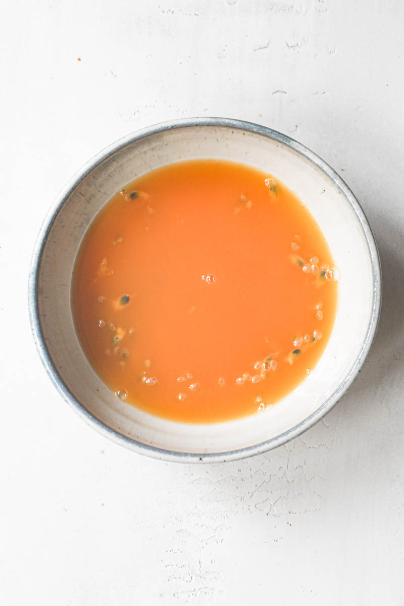The passion fruit jelly inside a grey bowl.