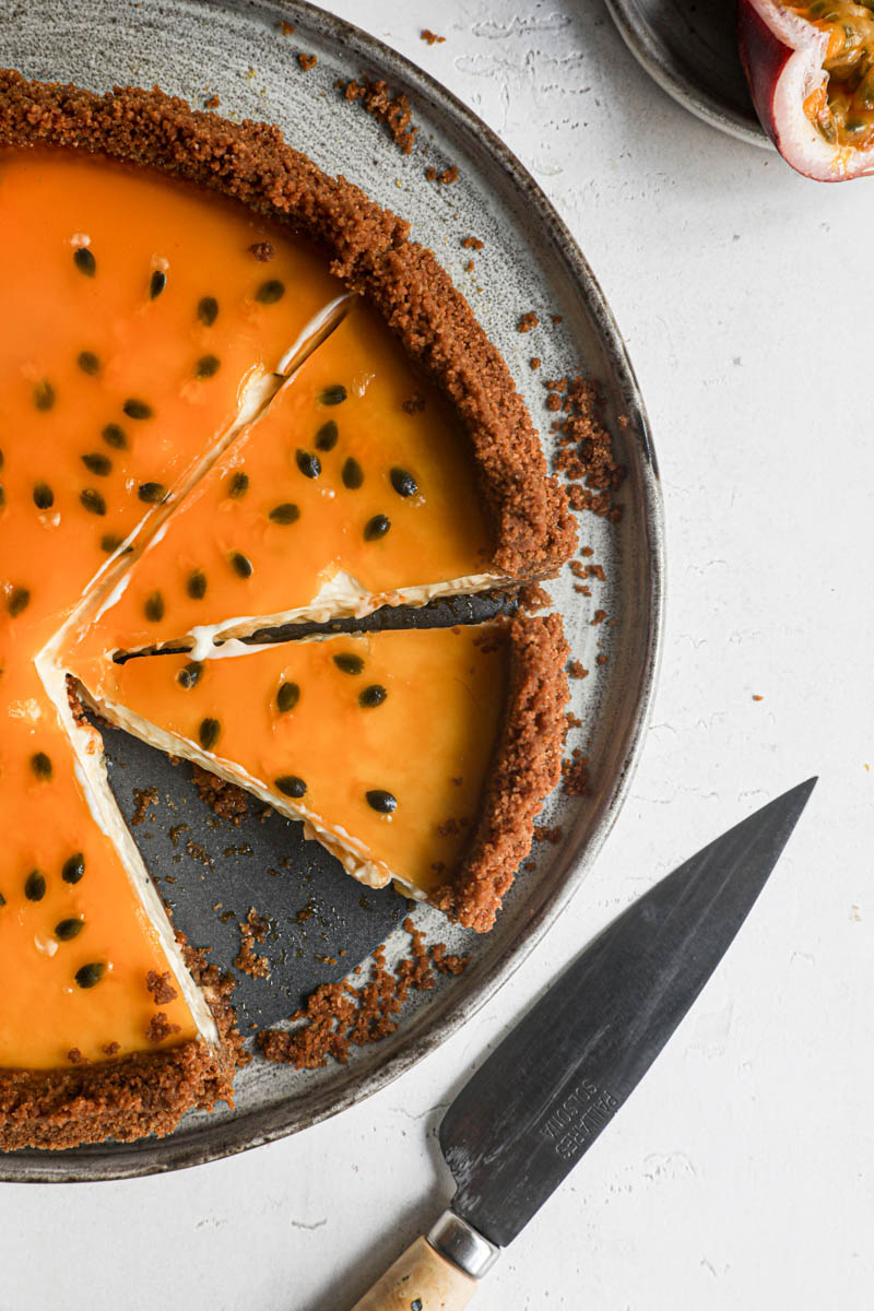 The sliced passion fruit cheesecake tart: a closeup.