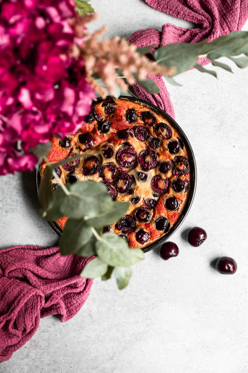 Overhead shot of the baked cherry clafoutis in the baking dish