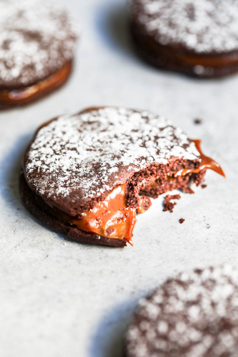 45° shot of one chocolate alfajor with a bite off