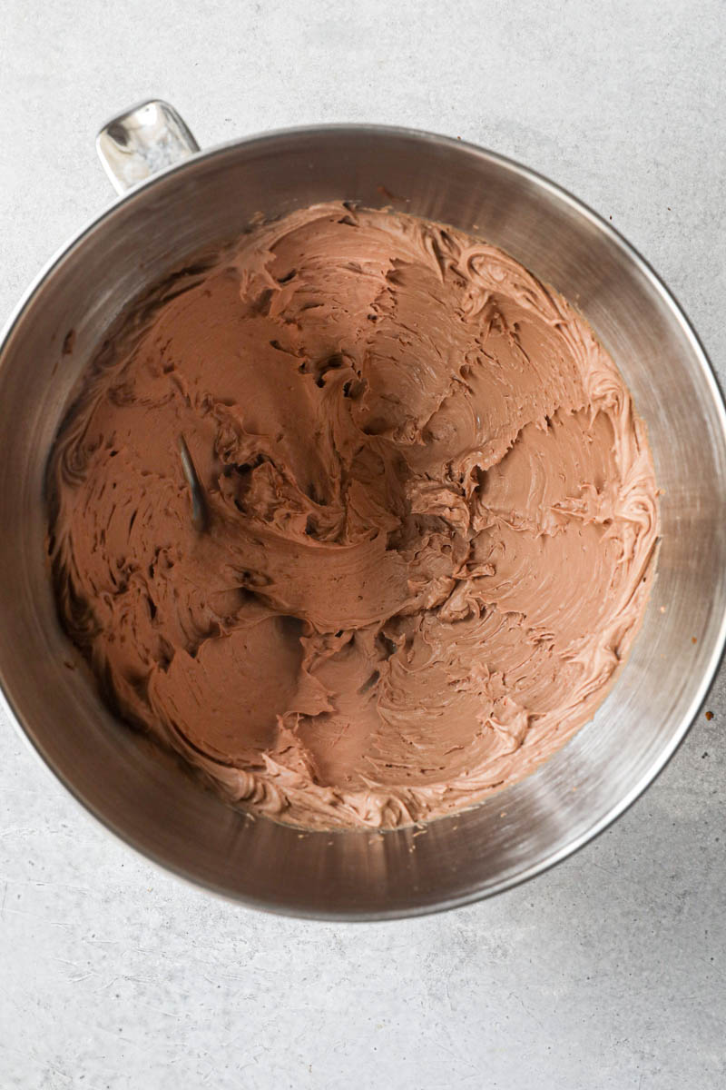 The whipped milk chocolate ganache inside a mixing bowl.
