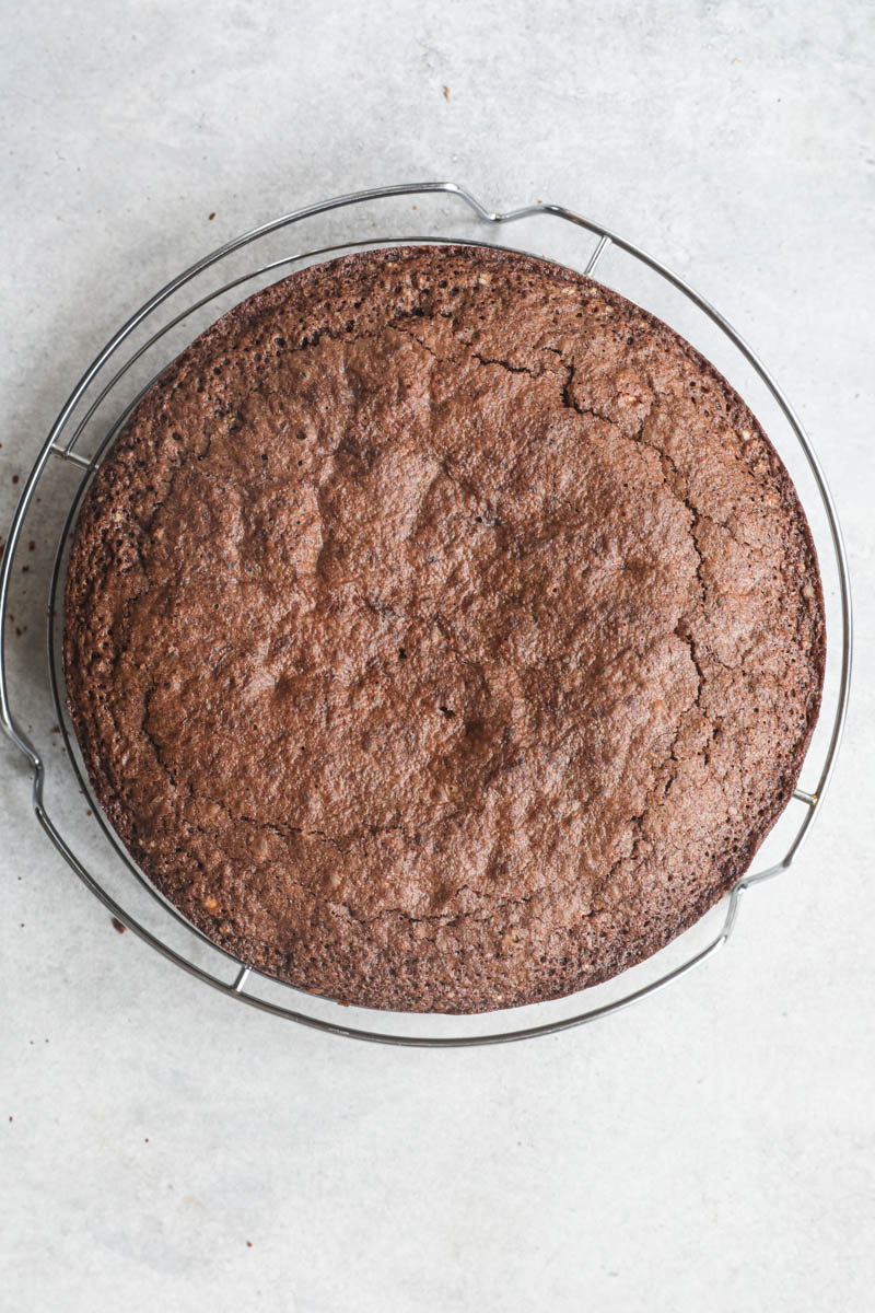 The baked chocolate hazelnut cake on top of a wire rack.