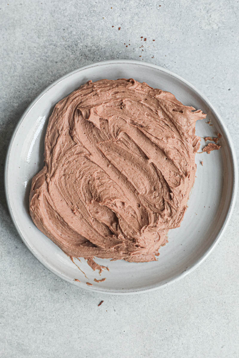 The whipped milk chocolate ganache on a grey plate.