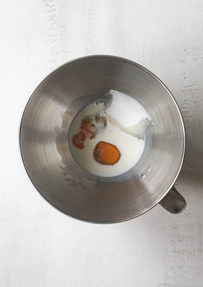 The eggs, sugar and milk inside a the mixing bowl.