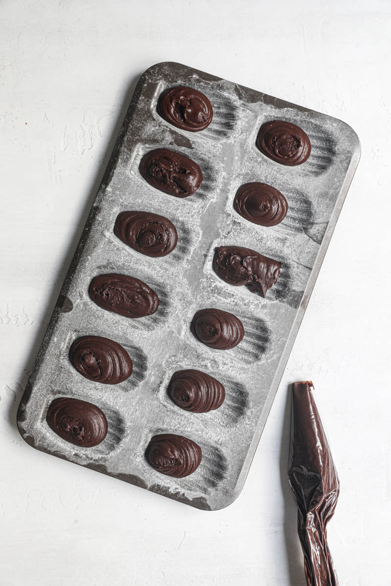 The madeleine tray filled with the chocolate madeleine batter ready for the oven.