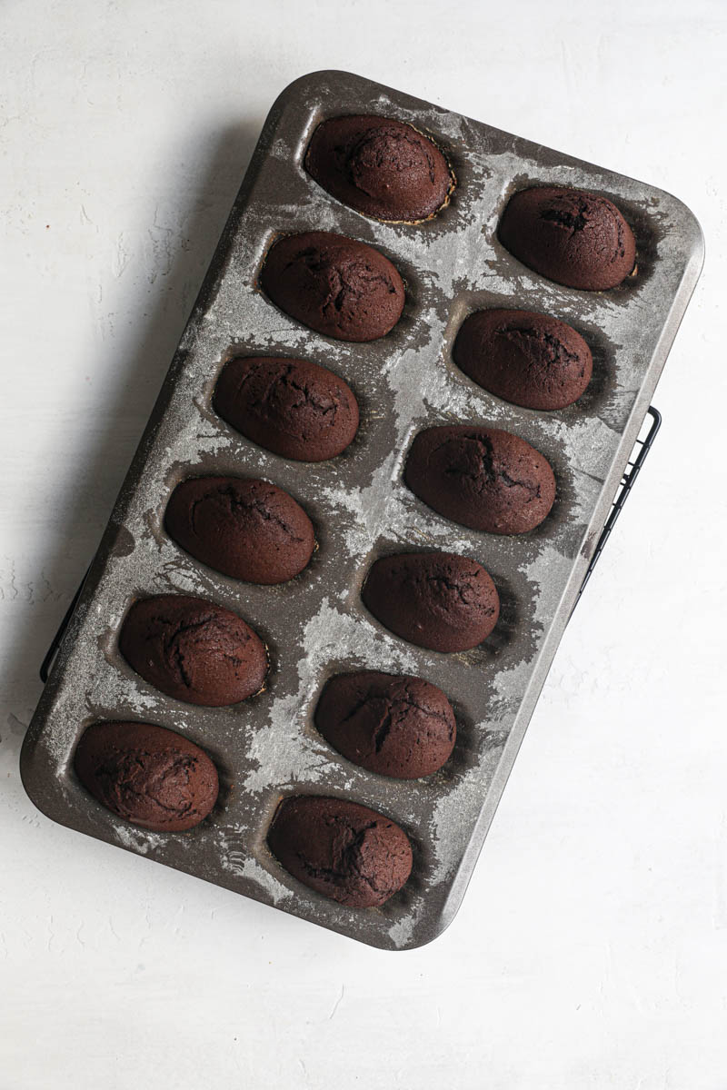 THe baked chocolate madeleines inside the baking tray.