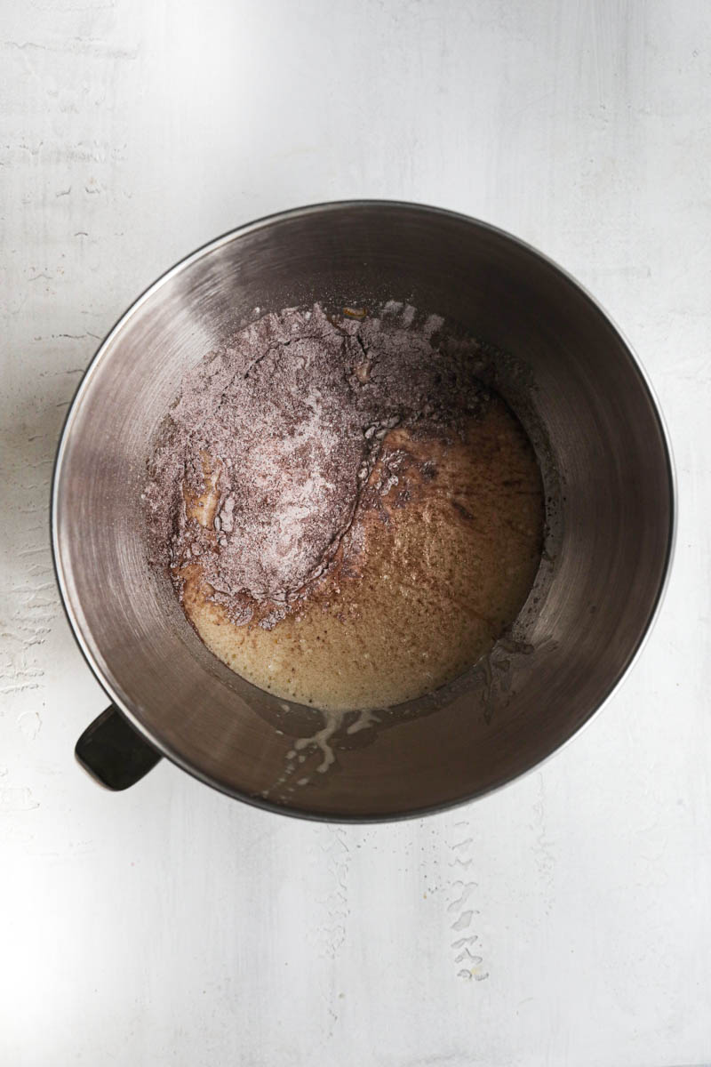 The beaten eggs, sugar and milk inside a mixing bowl plus the dry ingredients.