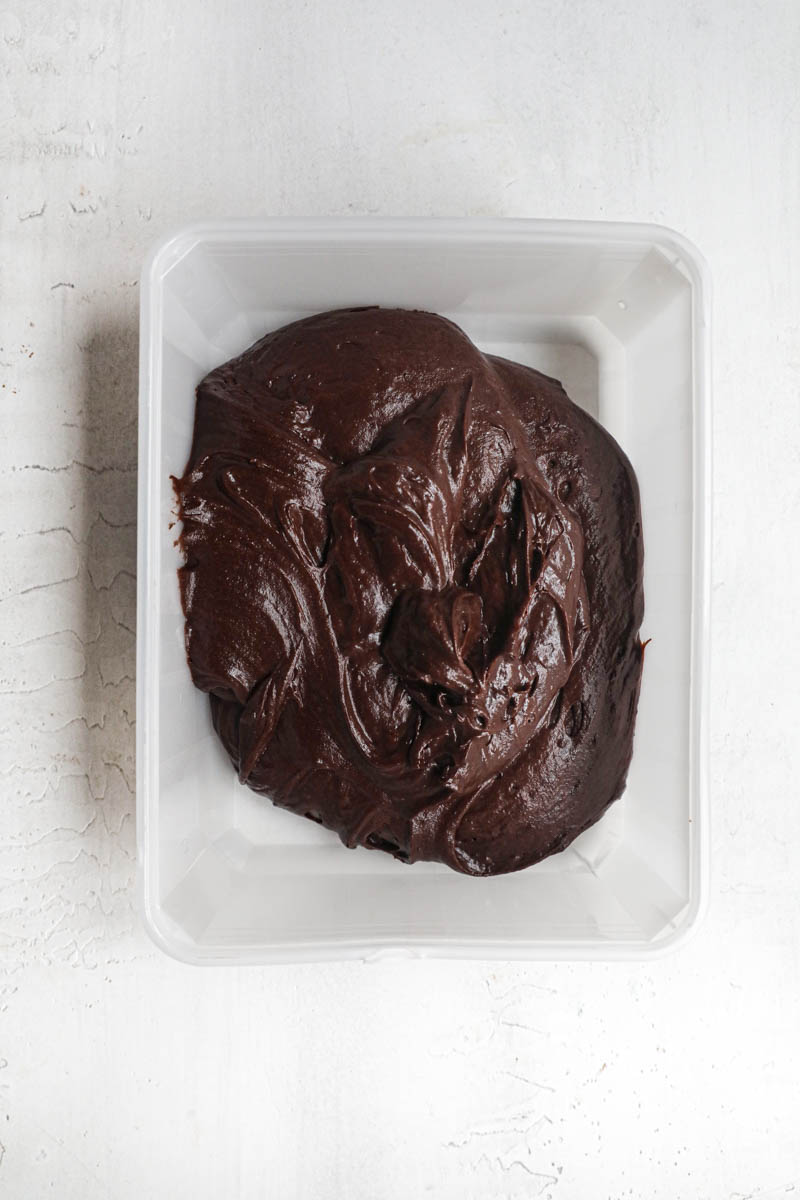 The chocolate madeleine inside a plastic container ready to be chilled.
