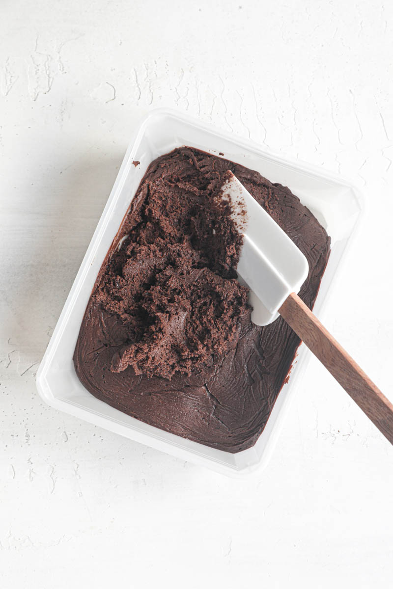 The chocolate madeleine inside a plastic container after it has been chilled for 24 hours.