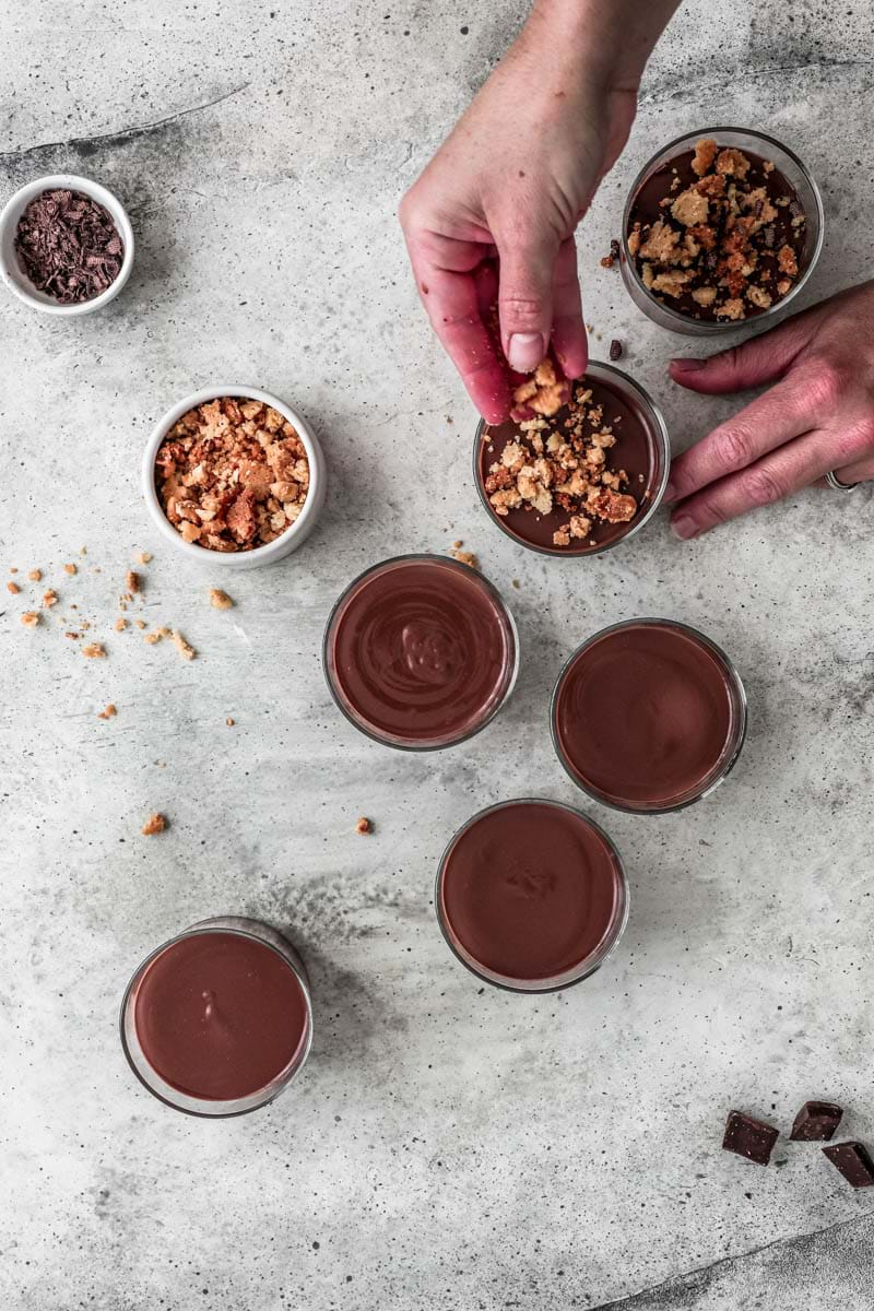 Top the chocolate pots de crème with some crumble topping and chocolate shavings