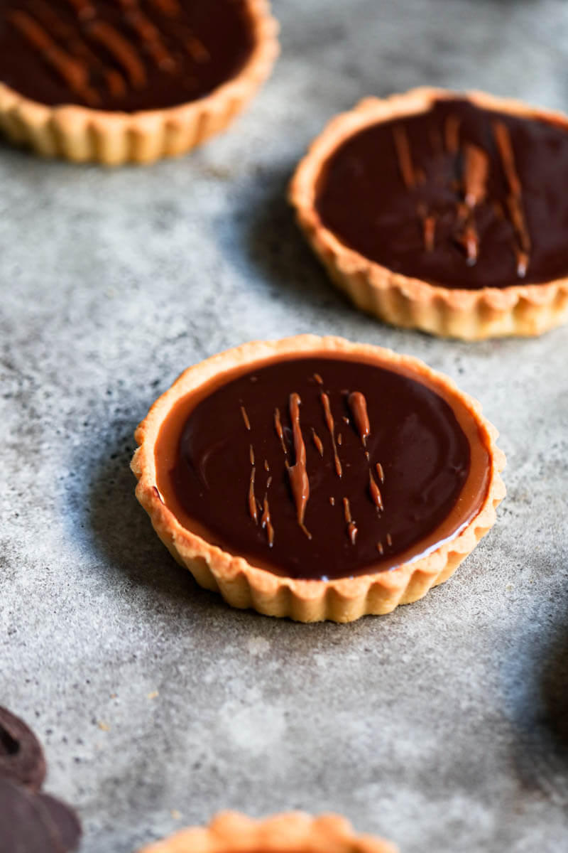 45° closeup shot of one chocolate salted caramel tartelette