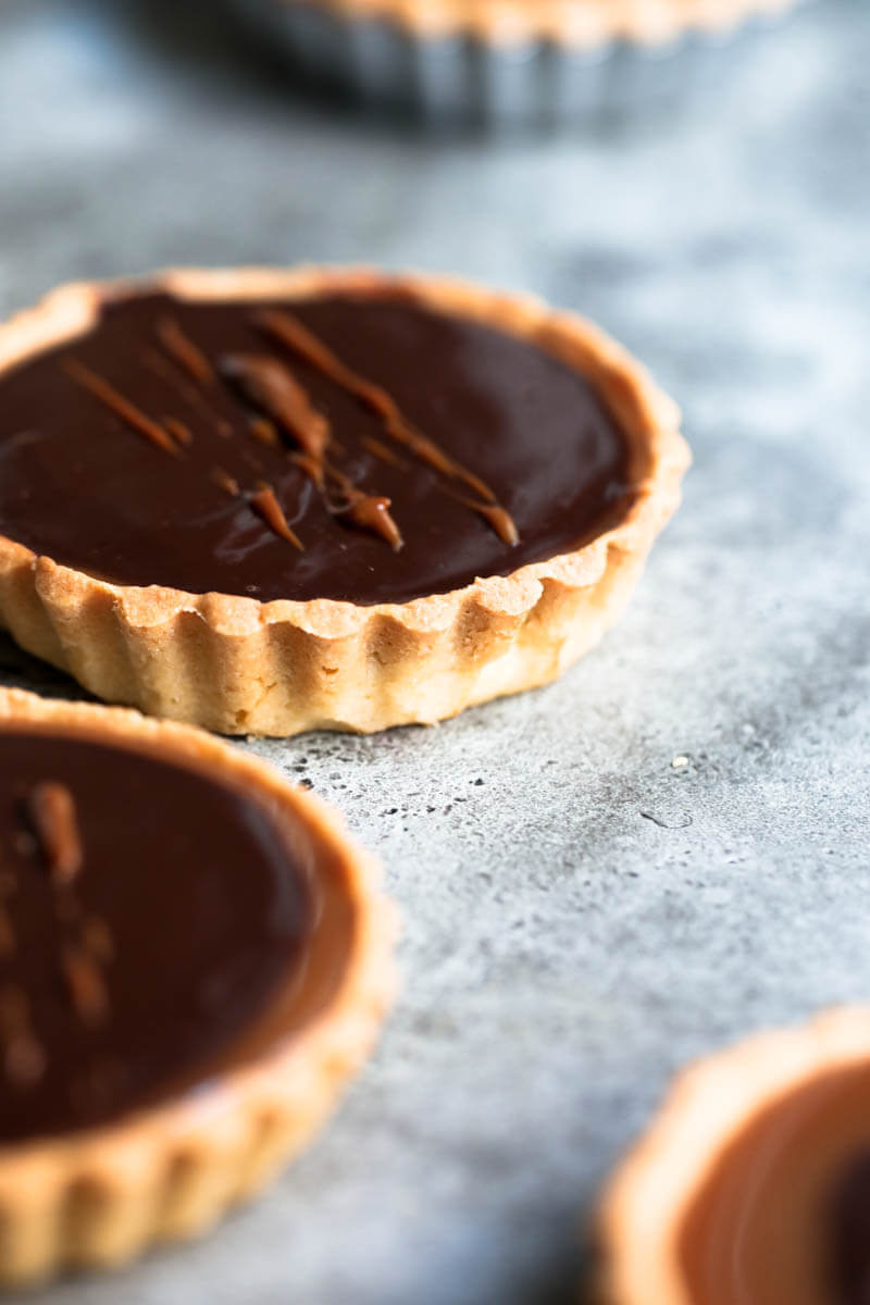 90° shot of one chocolate and salted caramel tartelette