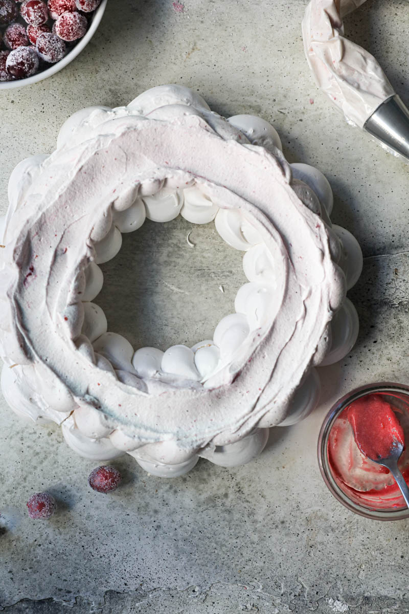 The Swiss meringue pavlova wreath covered with the cranberry cream.