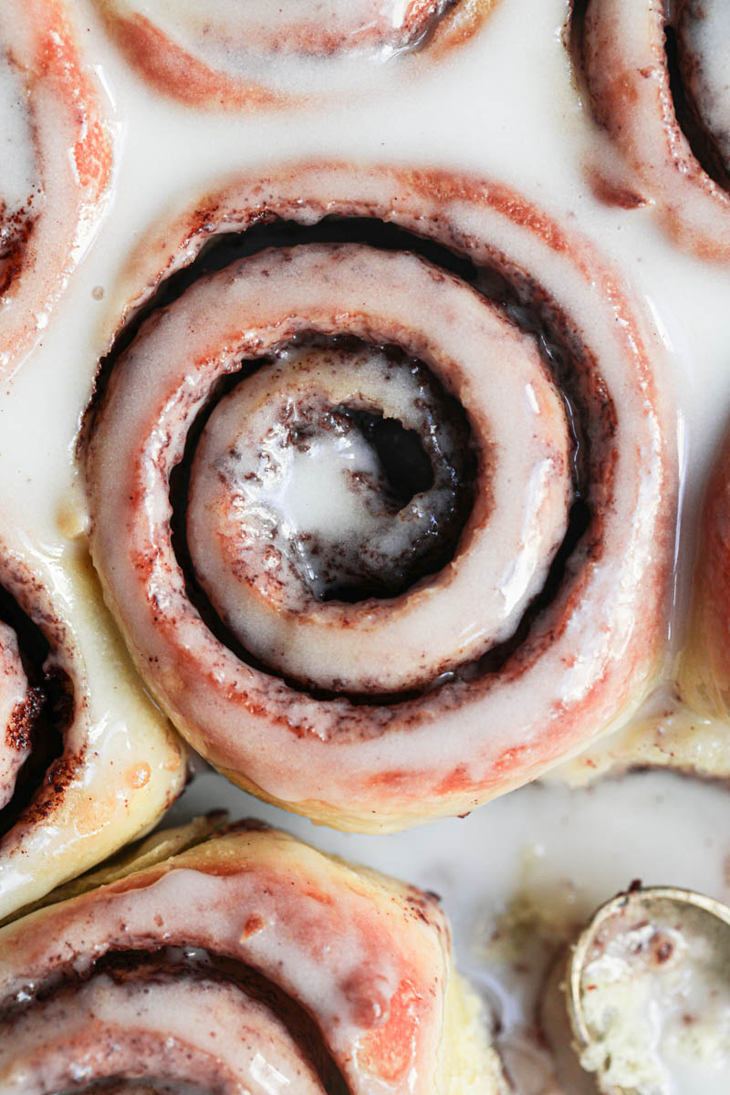 Closeup shot of the glazed brioche cinnamon rolls as seen from above.