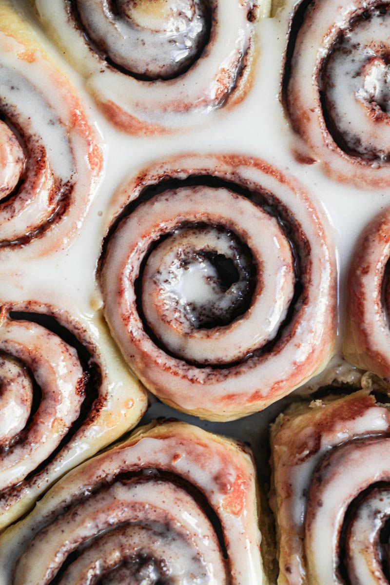 Closeup shot of the glazed brioche cinnamon rolls as seen from above.