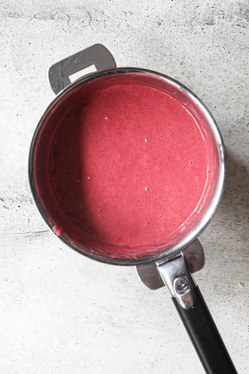 The cooked cranberry curd inside a pan.