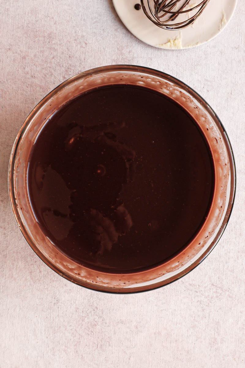 The creamy dark chocolate ganache inside a glass bowl.