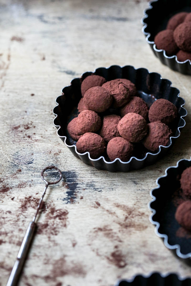 Truffles seen from the side with a chocolate fork on the side