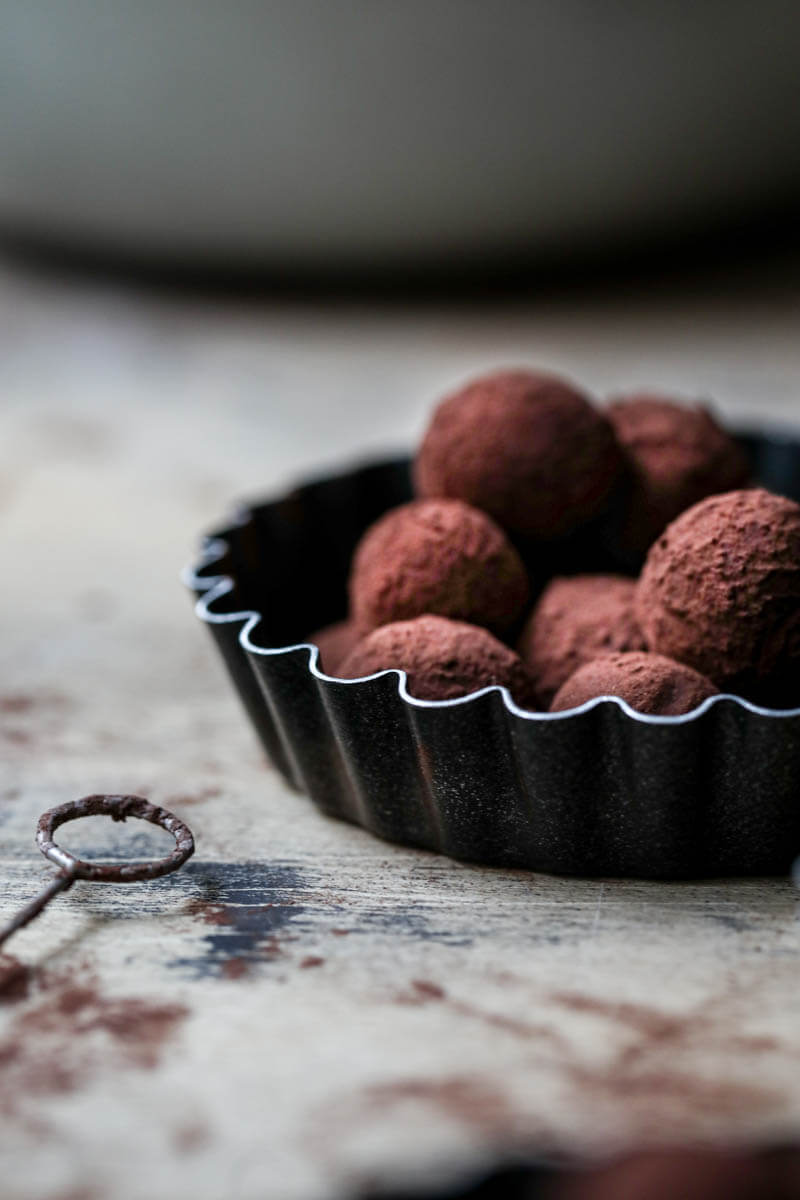 Truffles seen from the side with a chocolate fork on the side