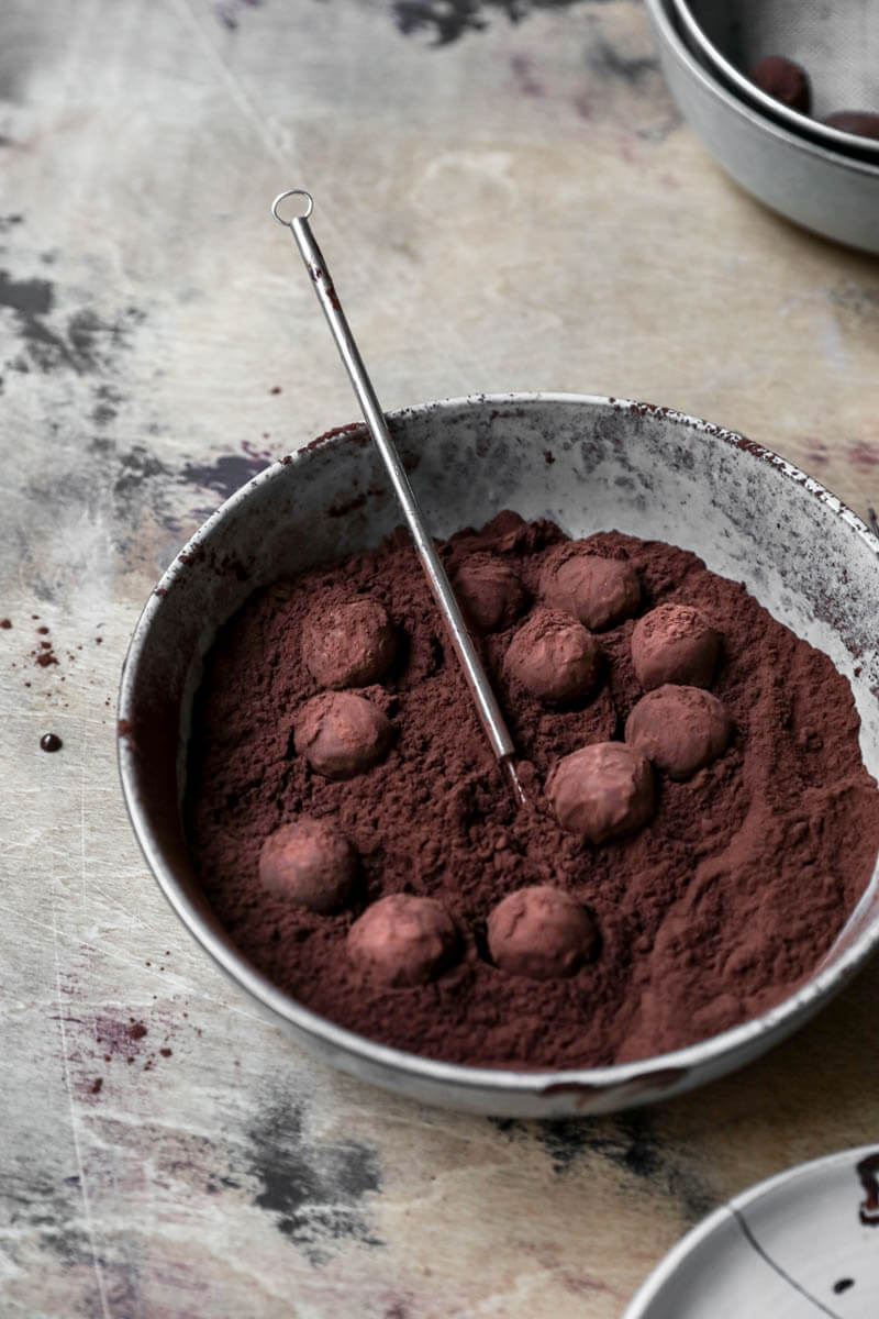 Plate filled with cocoa and chocolate truffles