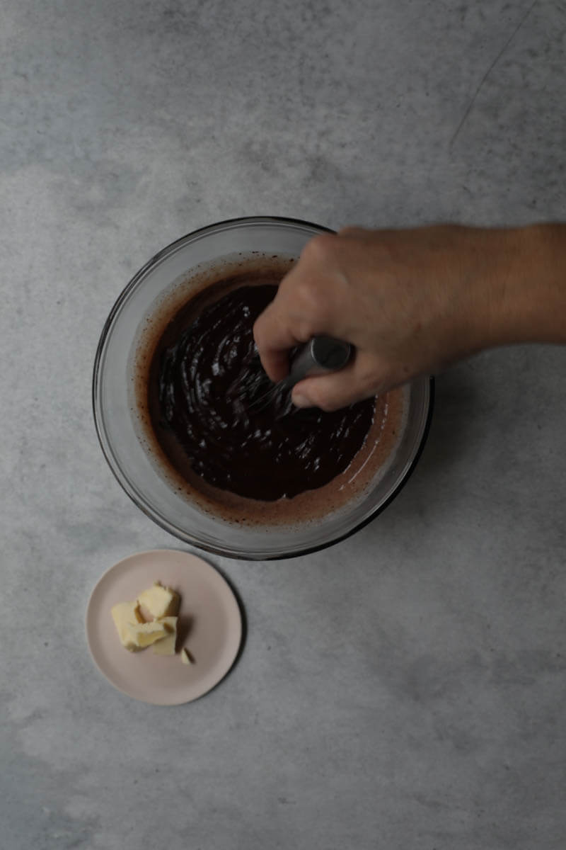Dark chocolate truffles on a black tart tin