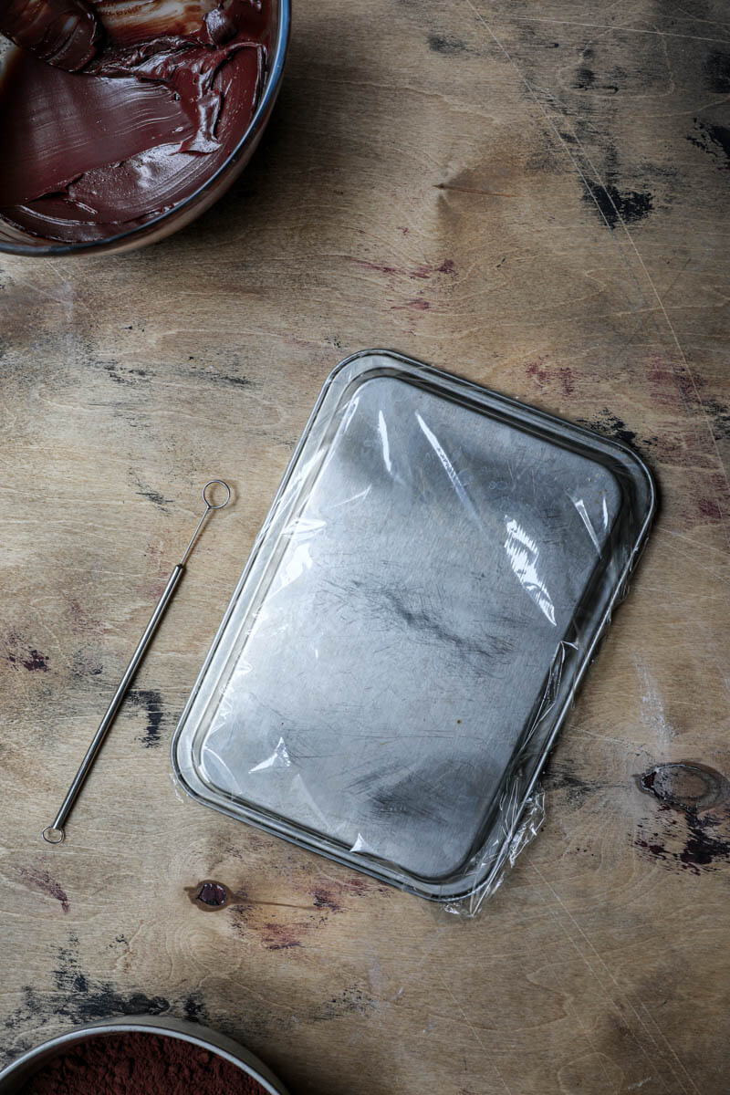 Baking tray covered with plastic wrap