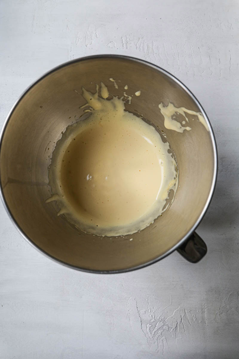 Eggs and egg yoks after whisking inside the mixing bowl.