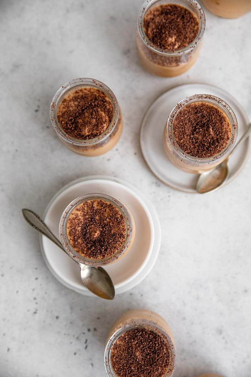 Overhead shot of the dulce de leche mousse served in small verrine glasses disposed on the form of a snake