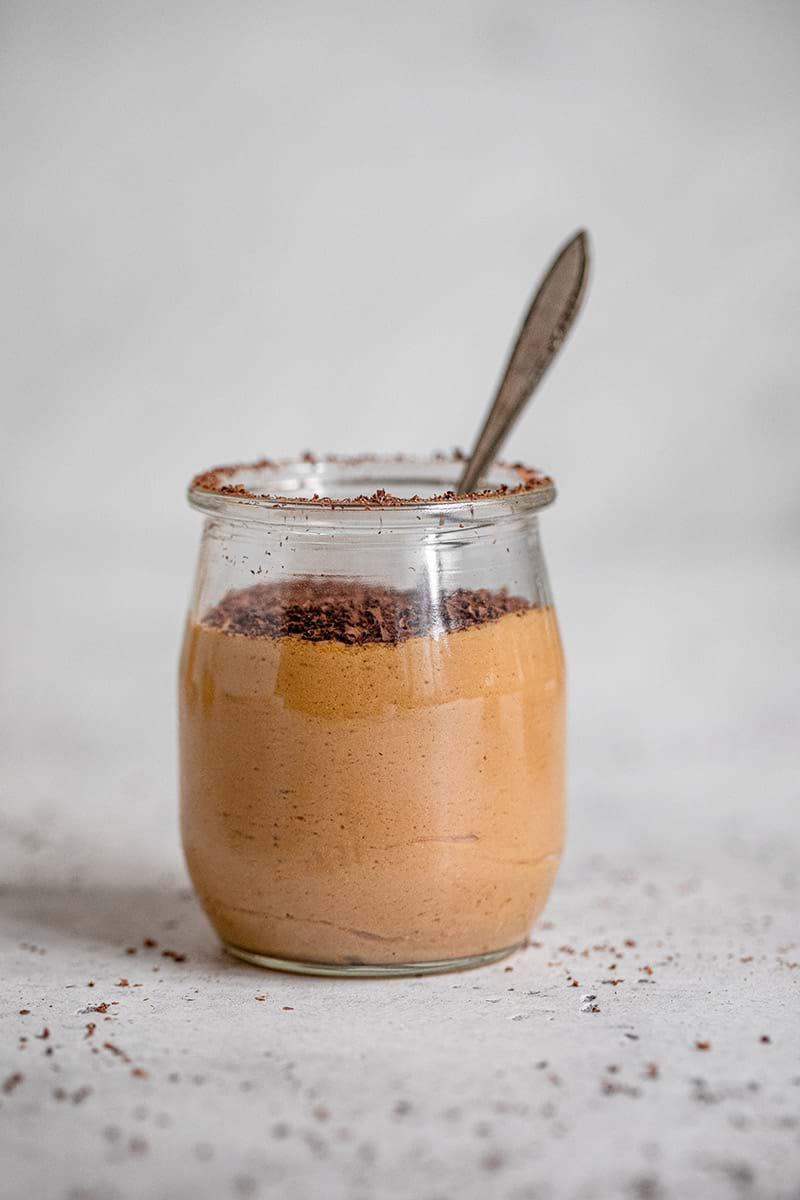 90° shot of one glass verrine filled with dulce de leche mousse topped with chocolate shavings
