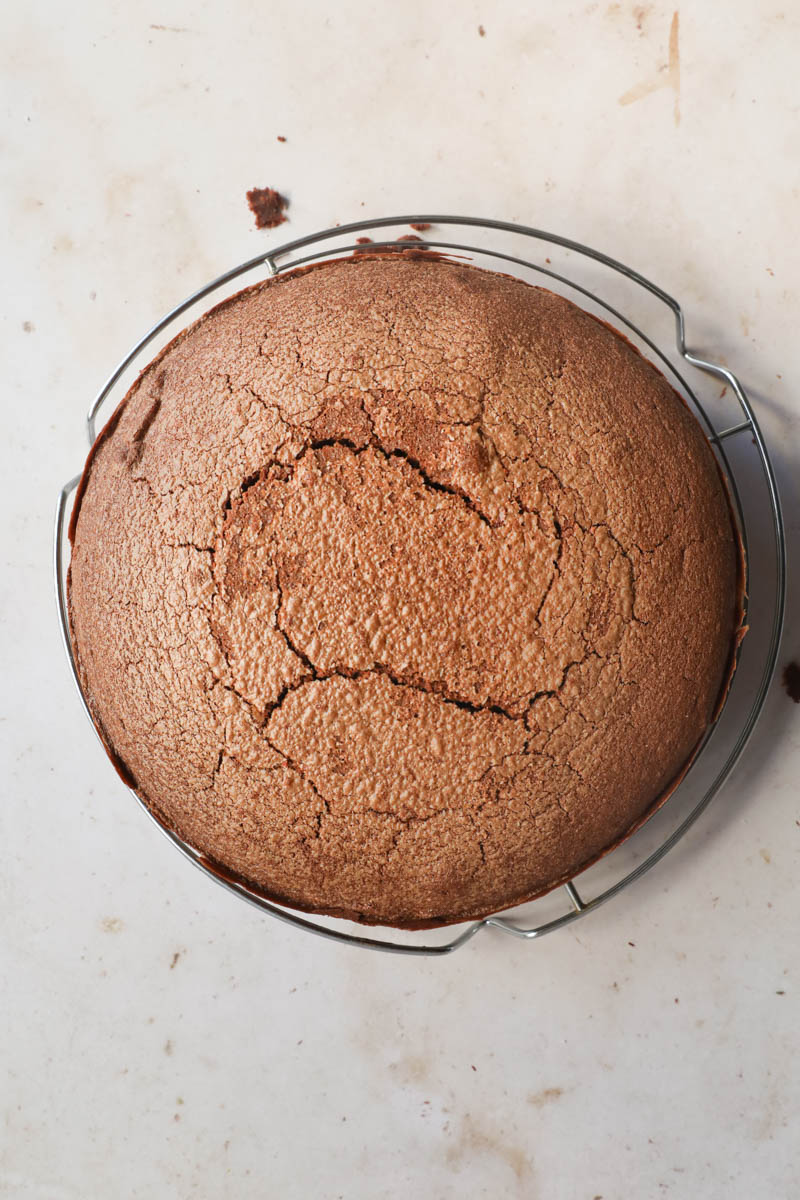 The baked French chocolate cake on top of a wire rack.