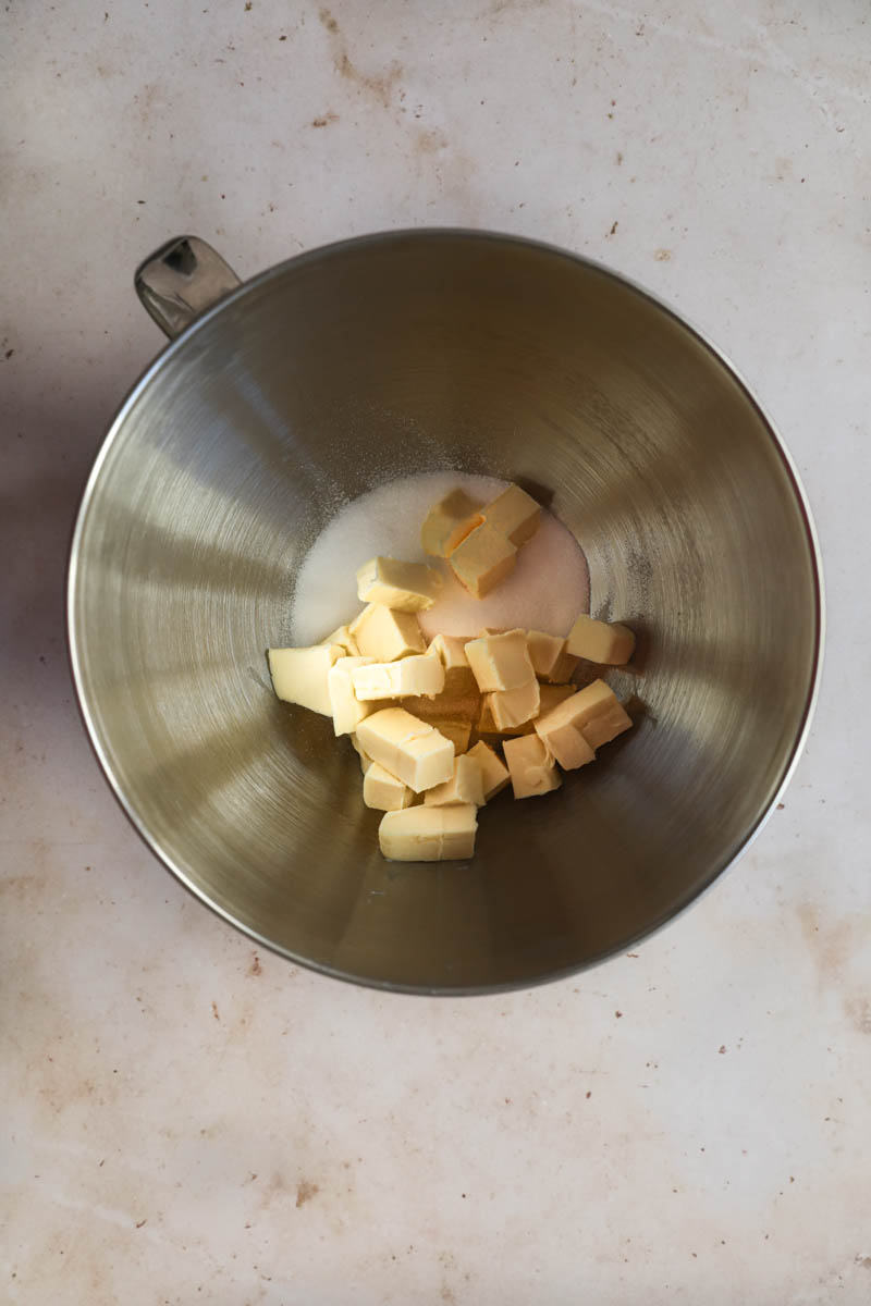 The sugar and the butter cut into cubes inside a mixing bowl ready to start the French Chocolate cake.