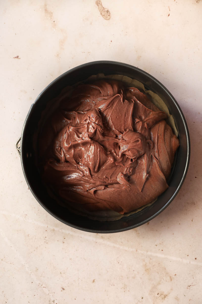 The French chocolate cake batter poured inside a springform cake pan.