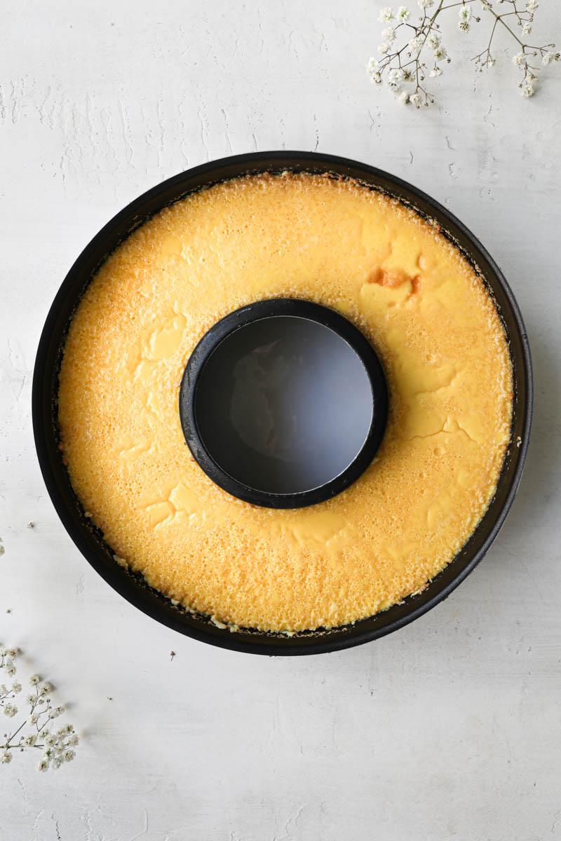 The baked flan inside a black flan pan.