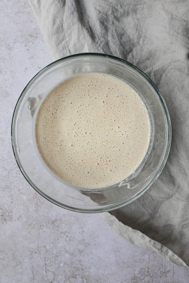 The crepe batter inside a glass bowl, after chilling.