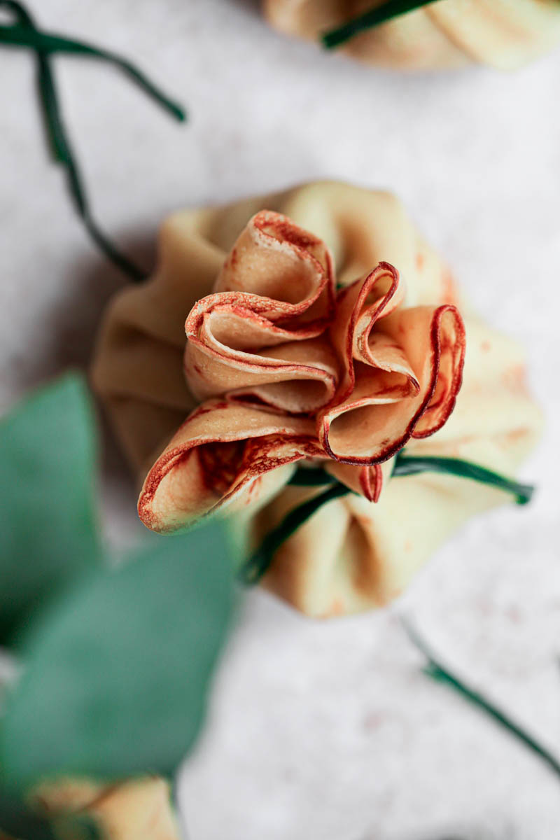 A closeup of one mushroom and chicken crepe as seen from above.